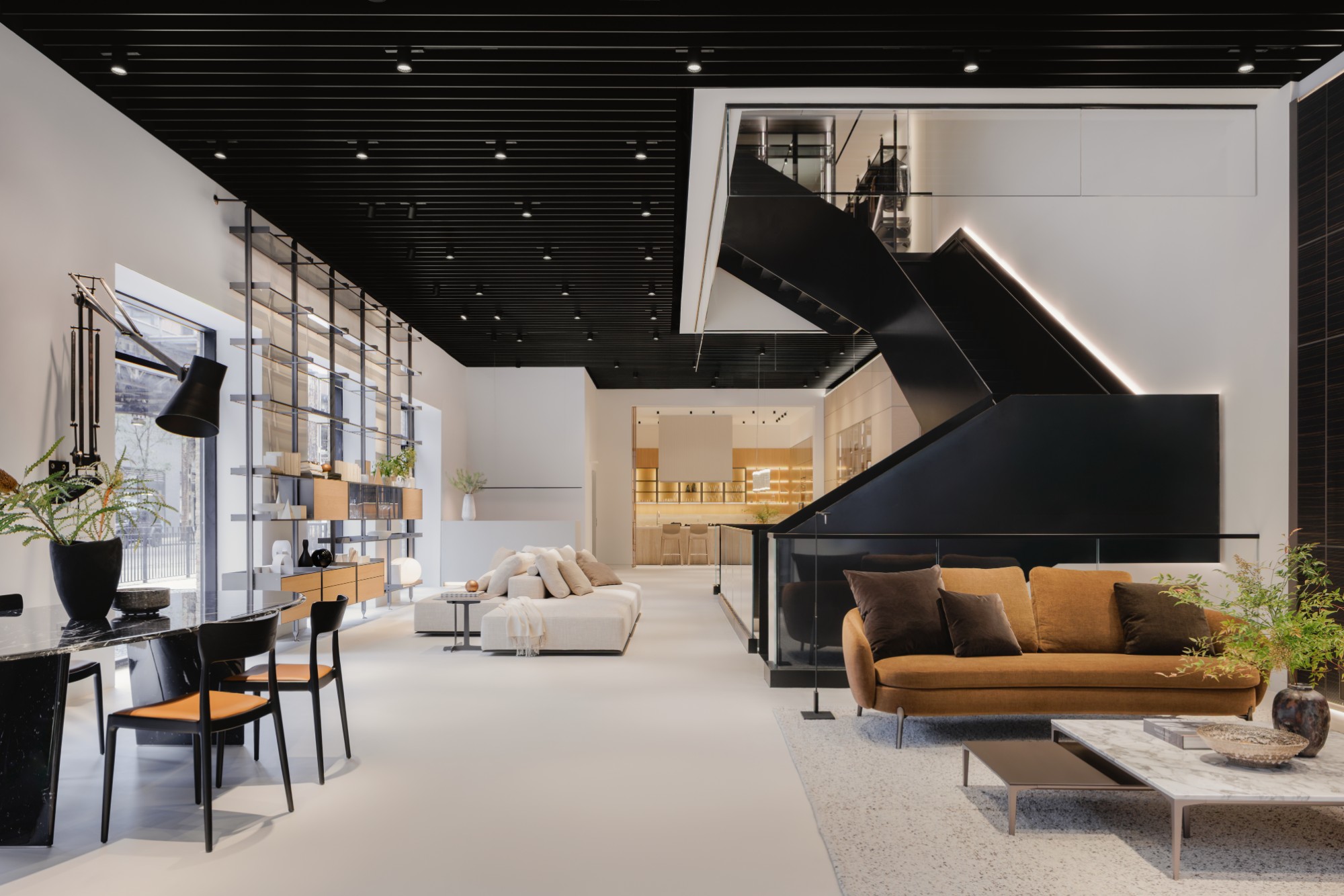 Inside, the ground floor gallery and its blackened-steel staircase