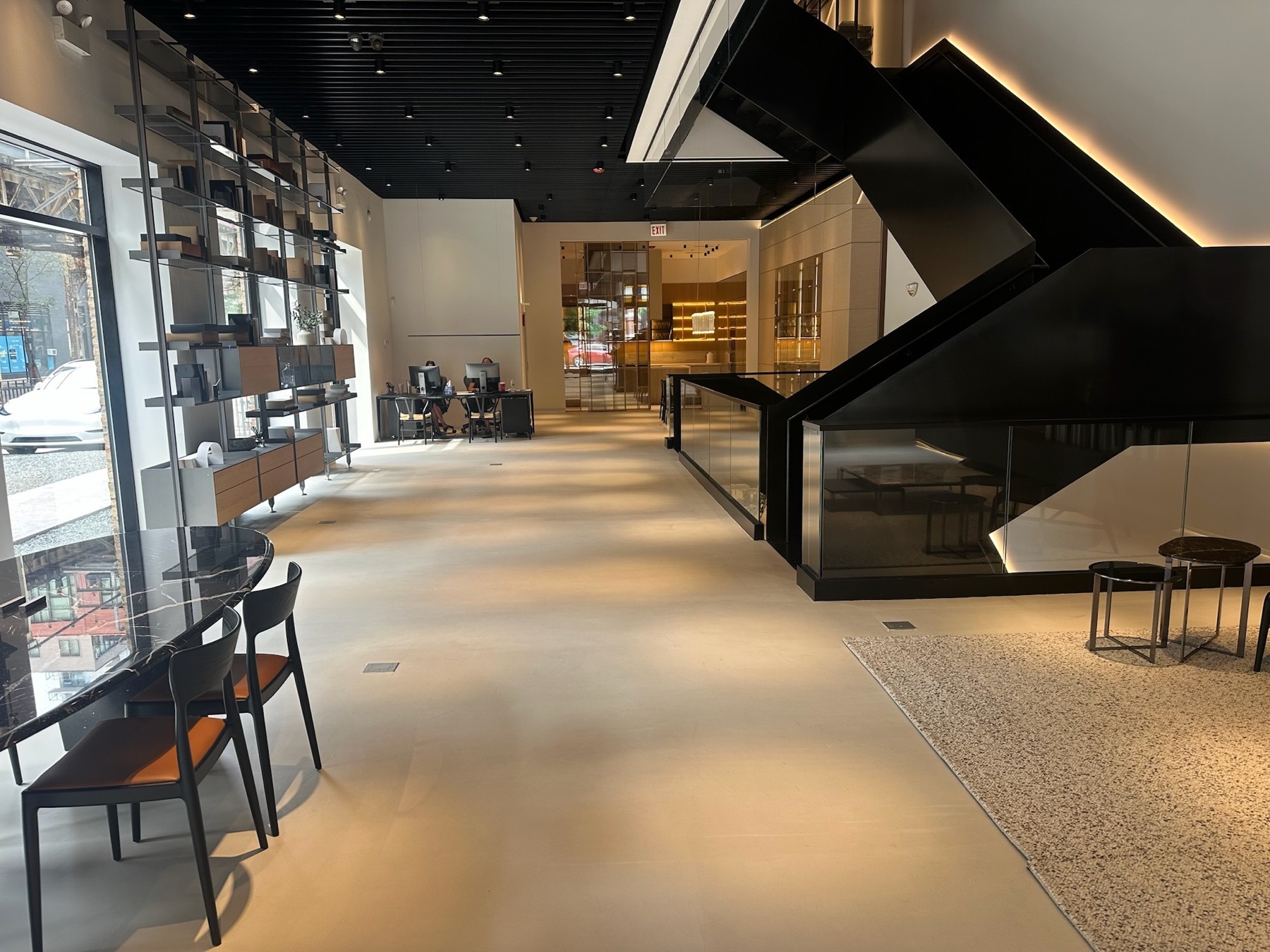The blackened-steel staircase rising through the ground floor